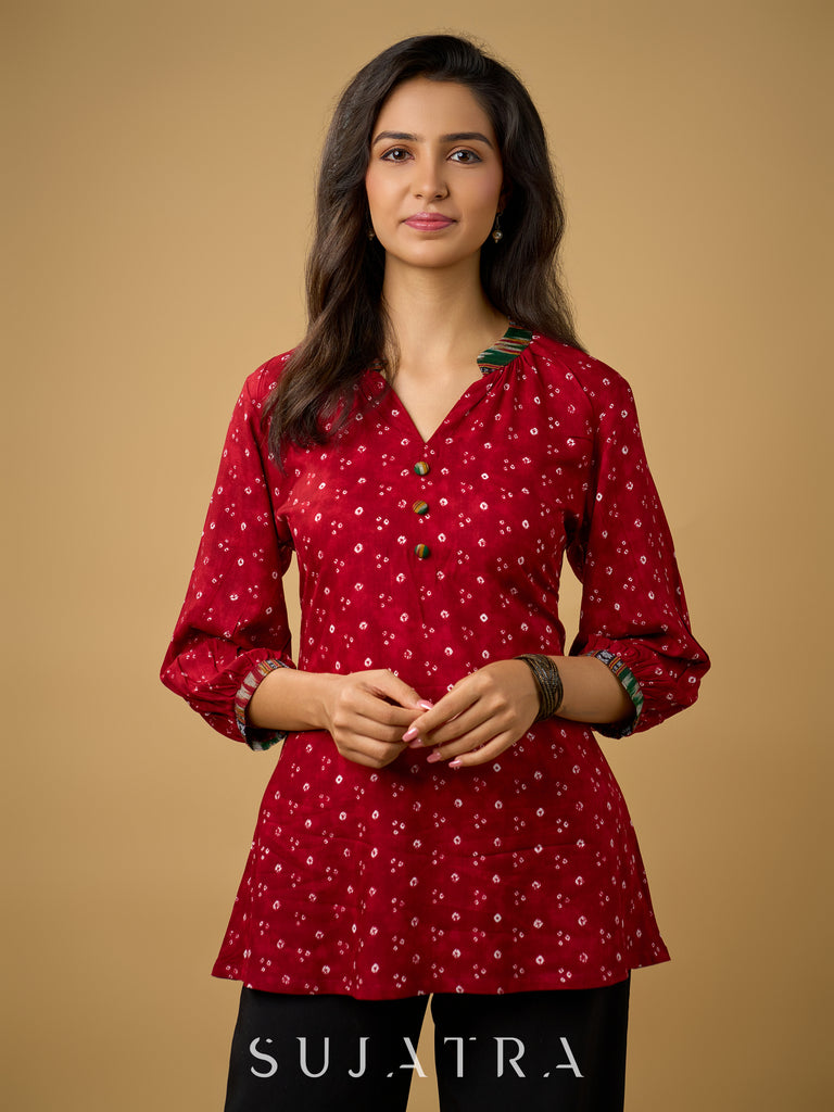 Red rayon bandhani top beautifully combined with classic ikat collar.
