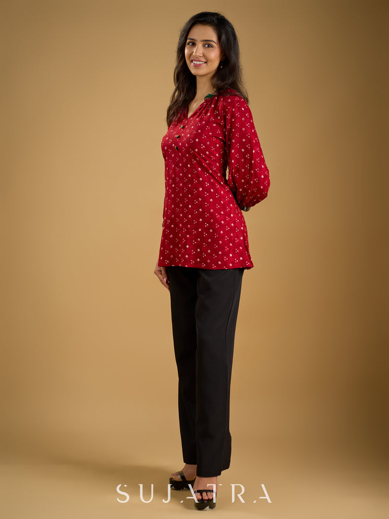 Red rayon bandhani top beautifully combined with classic ikat collar.