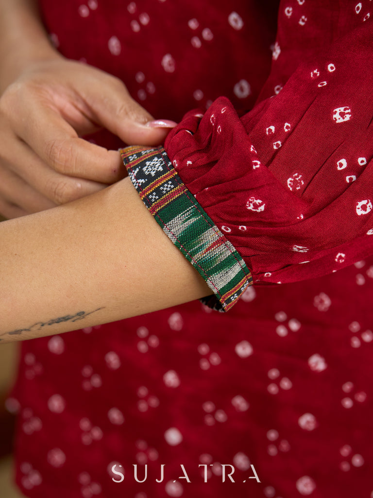 Red rayon bandhani top beautifully combined with classic ikat collar.