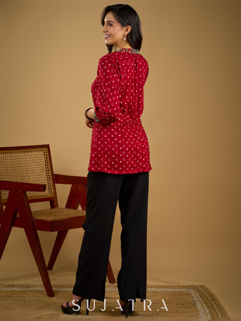 Red rayon bandhani top beautifully combined with classic ikat collar.