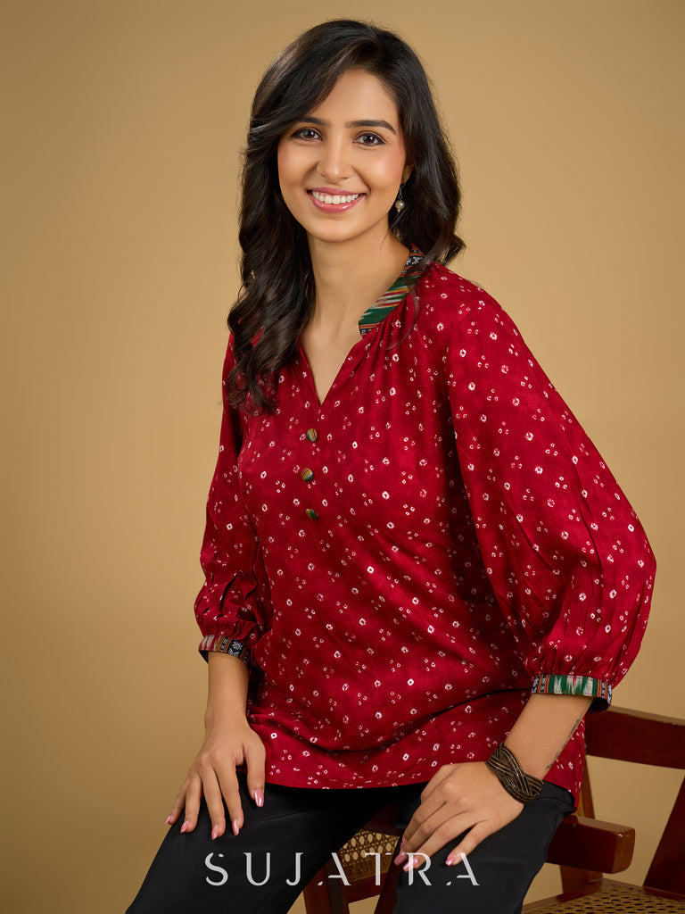 Red rayon bandhani top beautifully combined with classic ikat collar.
