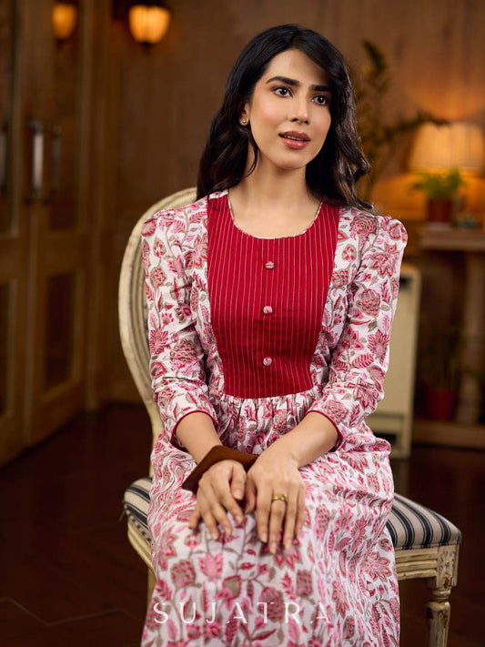 Elegant white floral Jaipuri printed dress with a delicately pintucked red panel, gathered sleeves, and rich red accents.