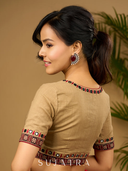 Exquisite hand embroidered dark beige ajrakh combination cotton blouse.