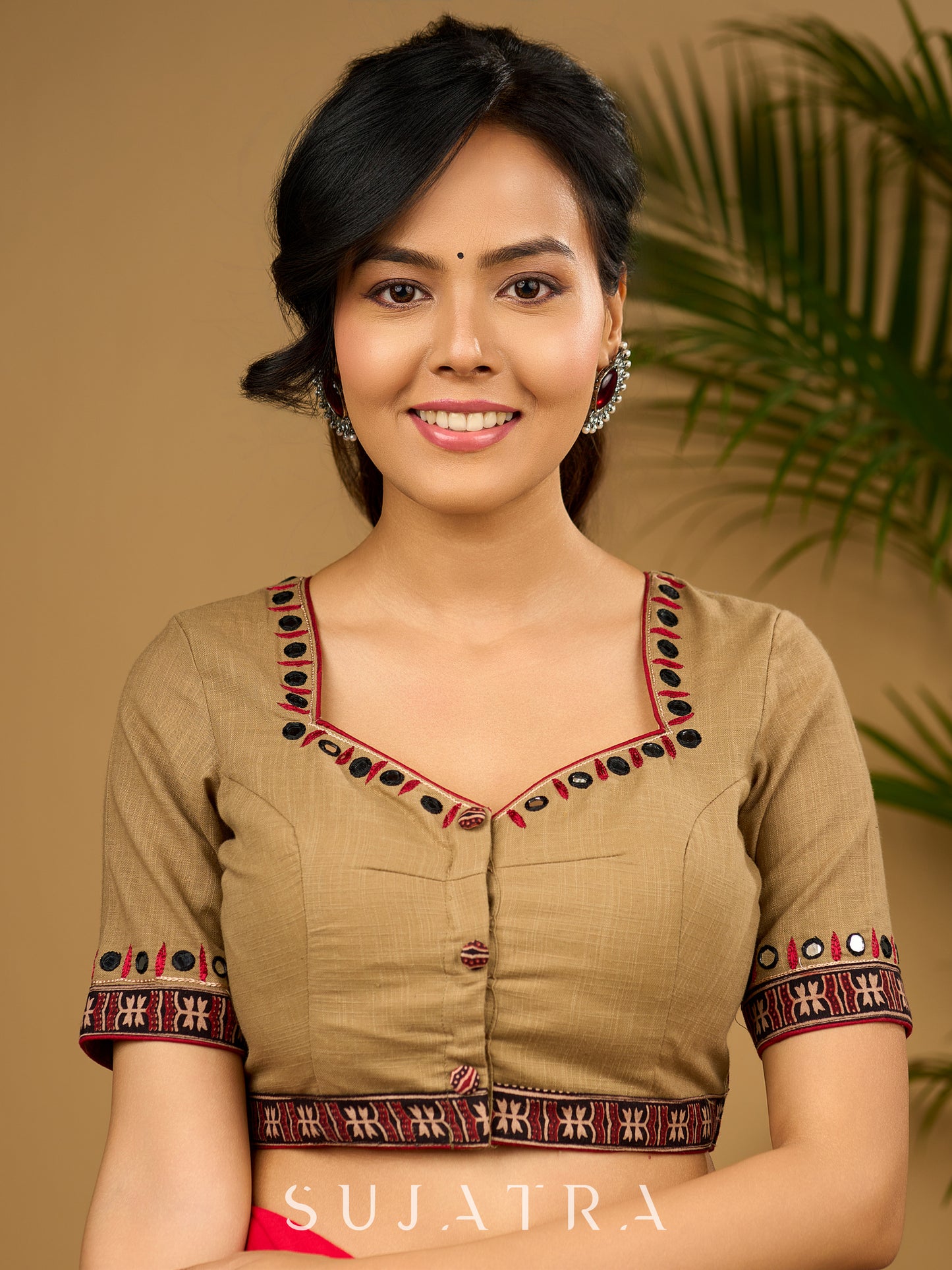 Exquisite hand embroidered dark beige ajrakh combination cotton blouse.