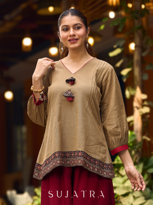 Beige Cotton Top Featuring Ajrakh Border, V Neckline, Gathered Sleeves And Fabric Tassels