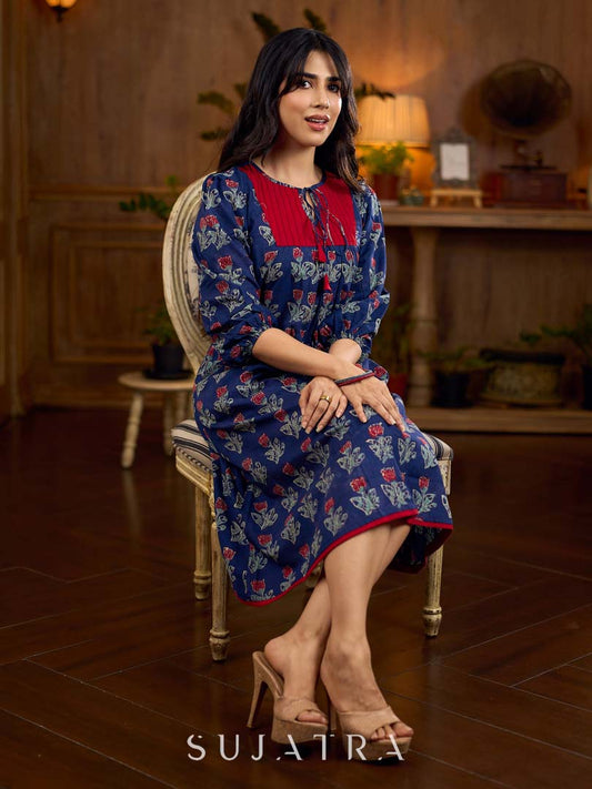 Royal blue Jaipur-printed dress featuring red rose motifs, a pintuck neck patch with red accents, and balloon 3/4th sleeves, creating a graceful silhouette with a blend of artisanal charm and contemporary elegance.