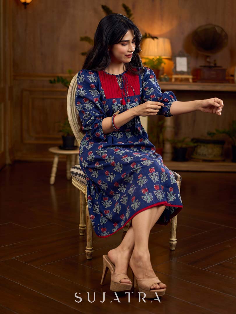 Royal blue Jaipur-printed dress featuring red rose motifs, a pintuck neck patch with red accents, and balloon 3/4th sleeves, creating a graceful silhouette with a blend of artisanal charm and contemporary elegance.
