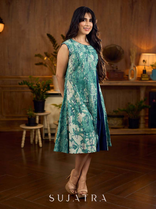 Indigo printed dress featuring playful fish motifs, designed in a gathered side-panel silhouette with contrast navy blue accents, creating a fluid, contemporary look with refined artisanal charm.