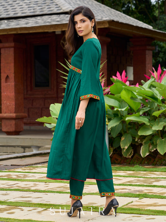 Beautiful Kutch mirror embroidery enriches this flared green rayon kurta - pant optional