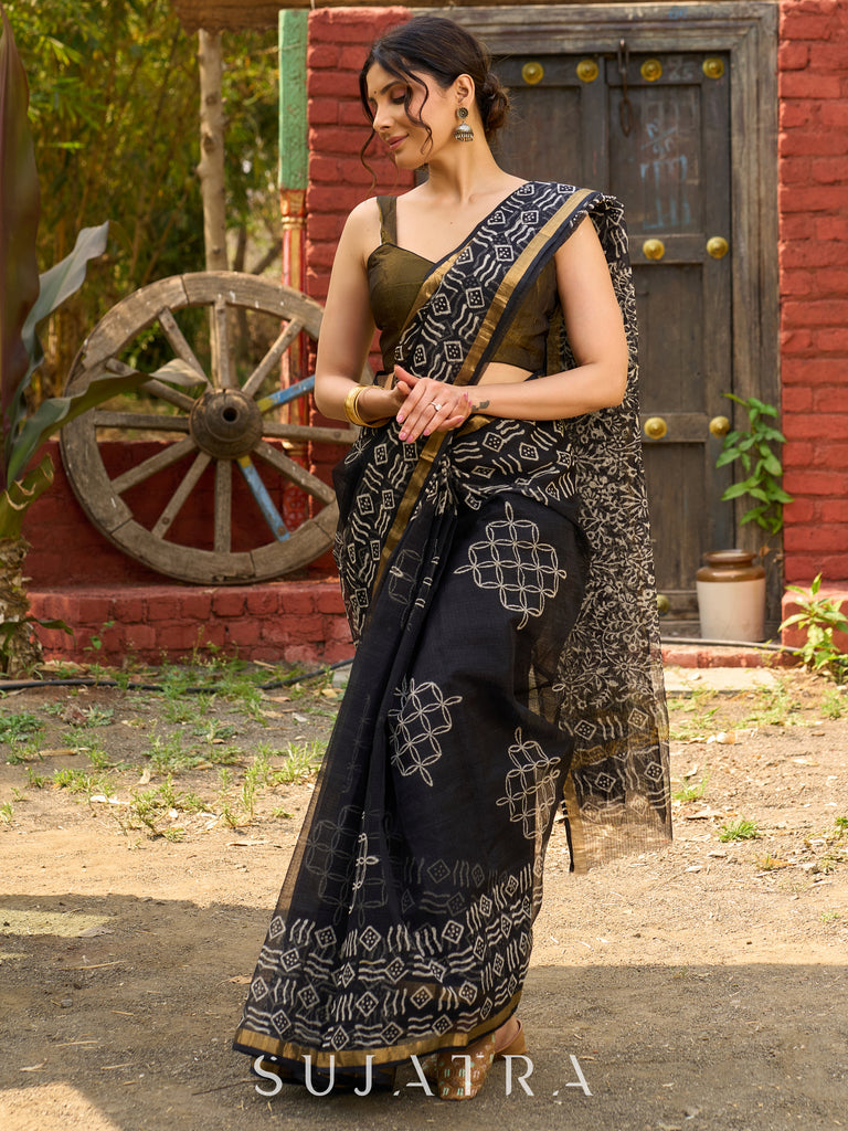 Classic black Kota saree with bold handblock prints and golden borders