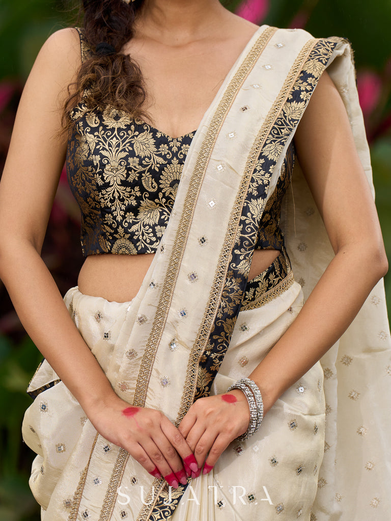 Timeless ivory tissue saree featuring zari embroidery and Banarasi accents