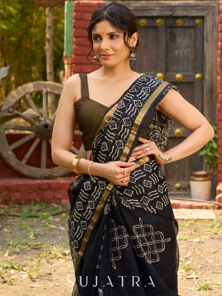 Classic black Kota saree with bold handblock prints and golden borders