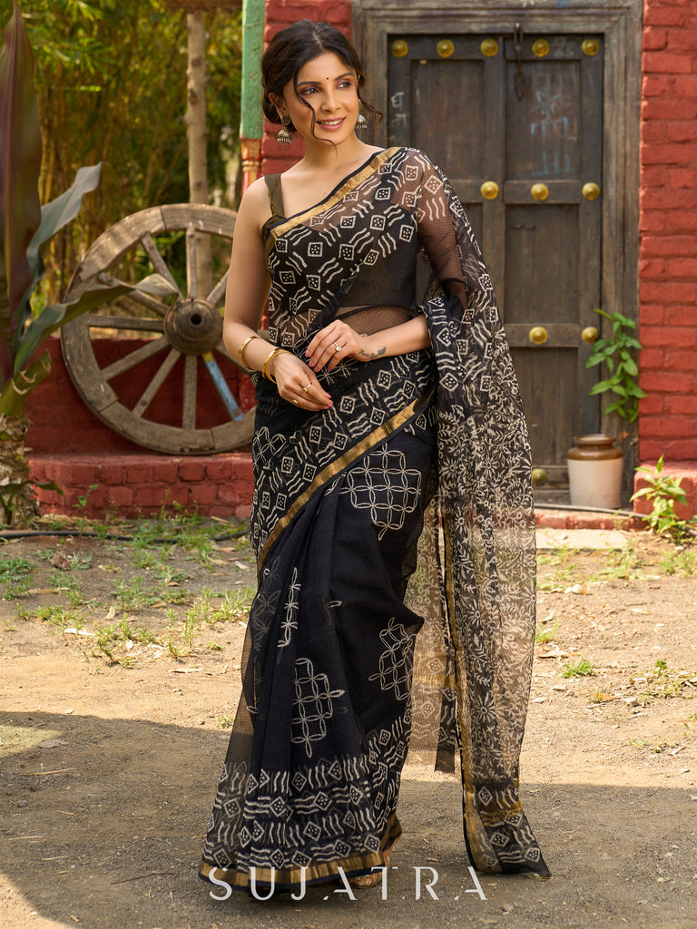 Classic black Kota saree with bold handblock prints and golden borders