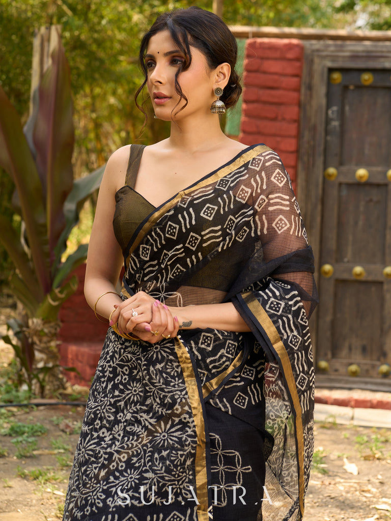 Classic black Kota saree with bold handblock prints and golden borders
