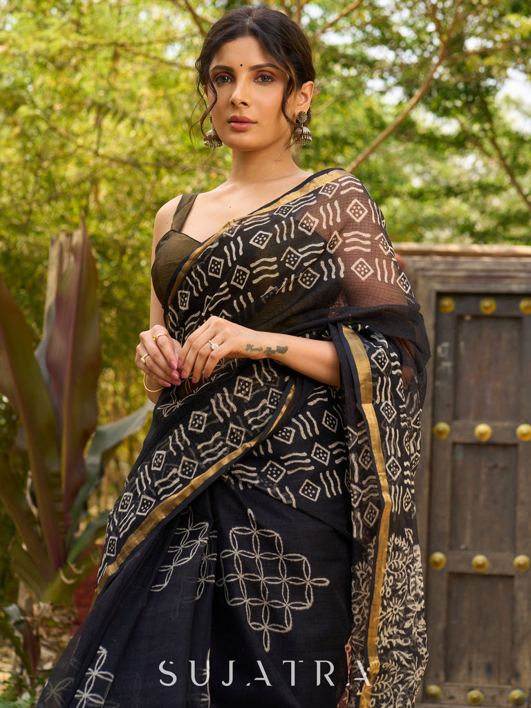 Classic black Kota saree with bold handblock prints and golden borders