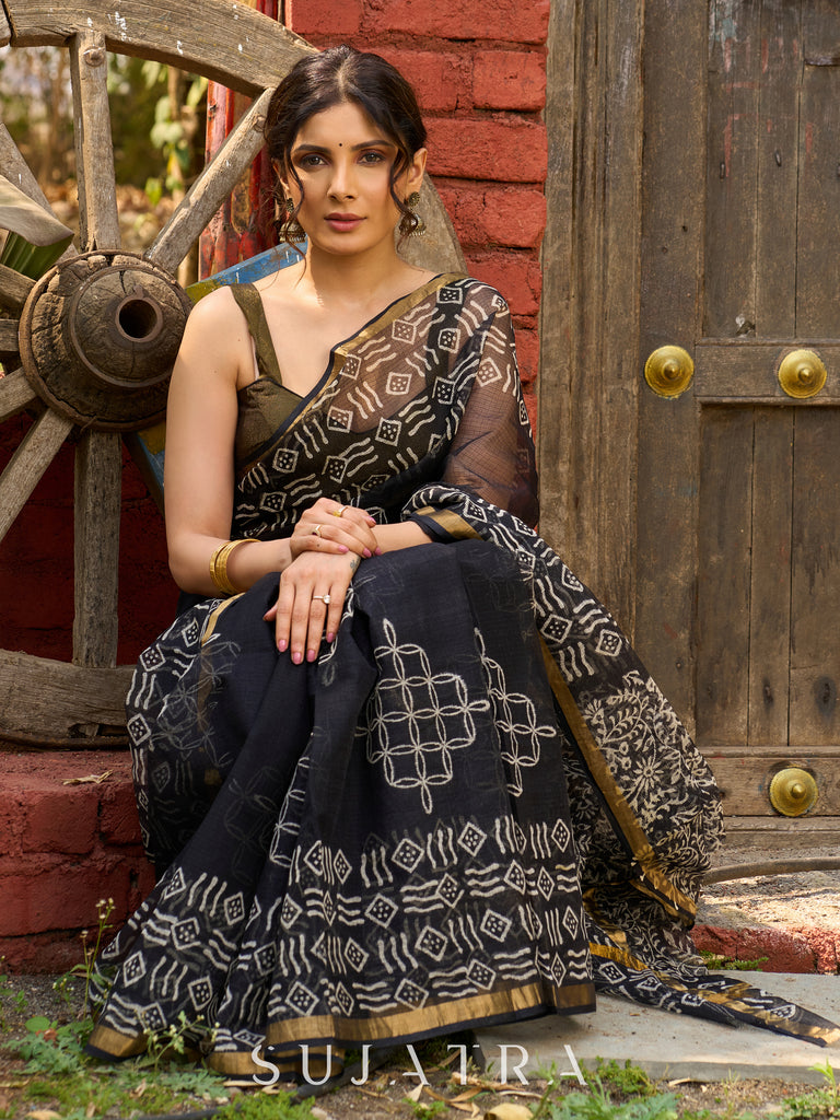 Classic black Kota saree with bold handblock prints and golden borders