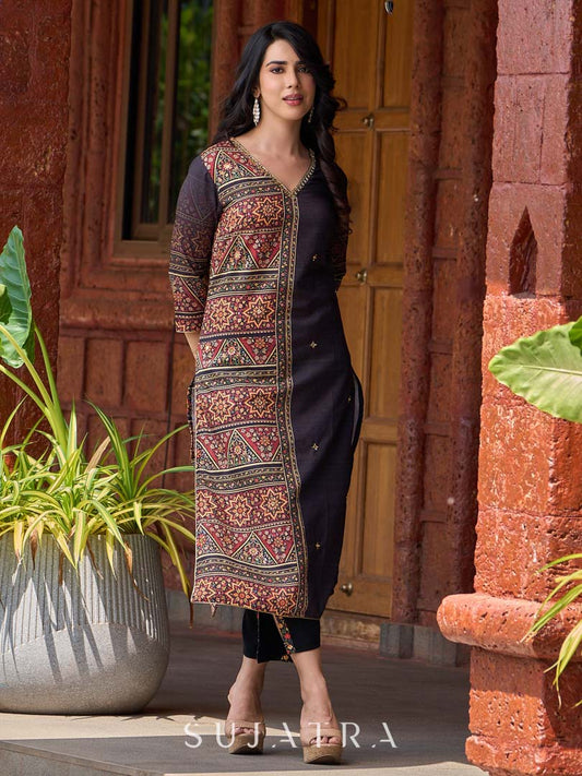 Striking black half-and-half kurta with geometric traditional prints, delicate hand embroidery, mirror work details, and ombré printed sleeves.