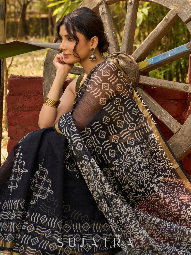 Classic black Kota saree with bold handblock prints and golden borders