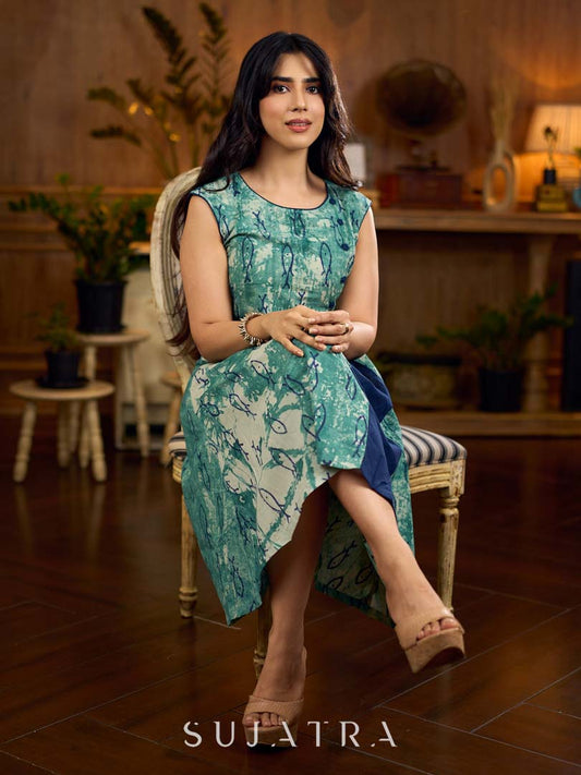 Indigo printed dress featuring playful fish motifs, designed in a gathered side-panel silhouette with contrast navy blue accents, creating a fluid, contemporary look with refined artisanal charm.