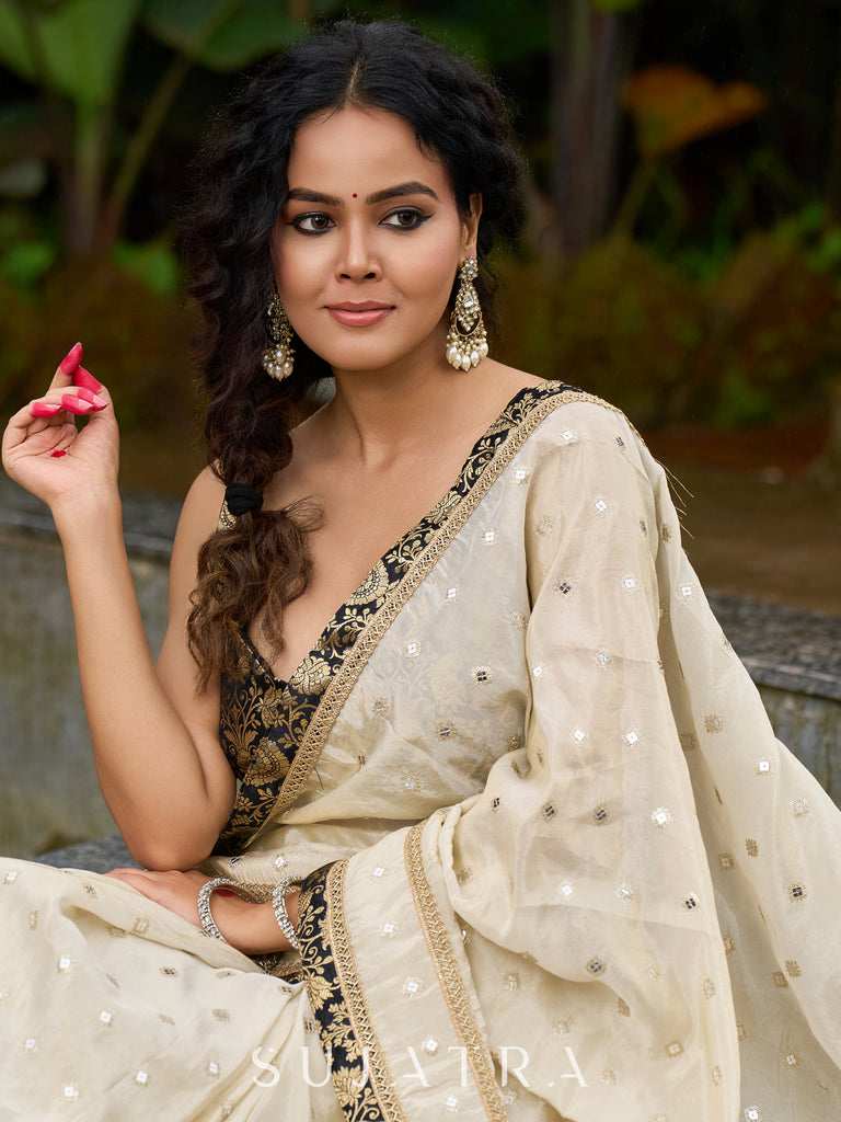 Timeless ivory tissue saree featuring zari embroidery and Banarasi accents