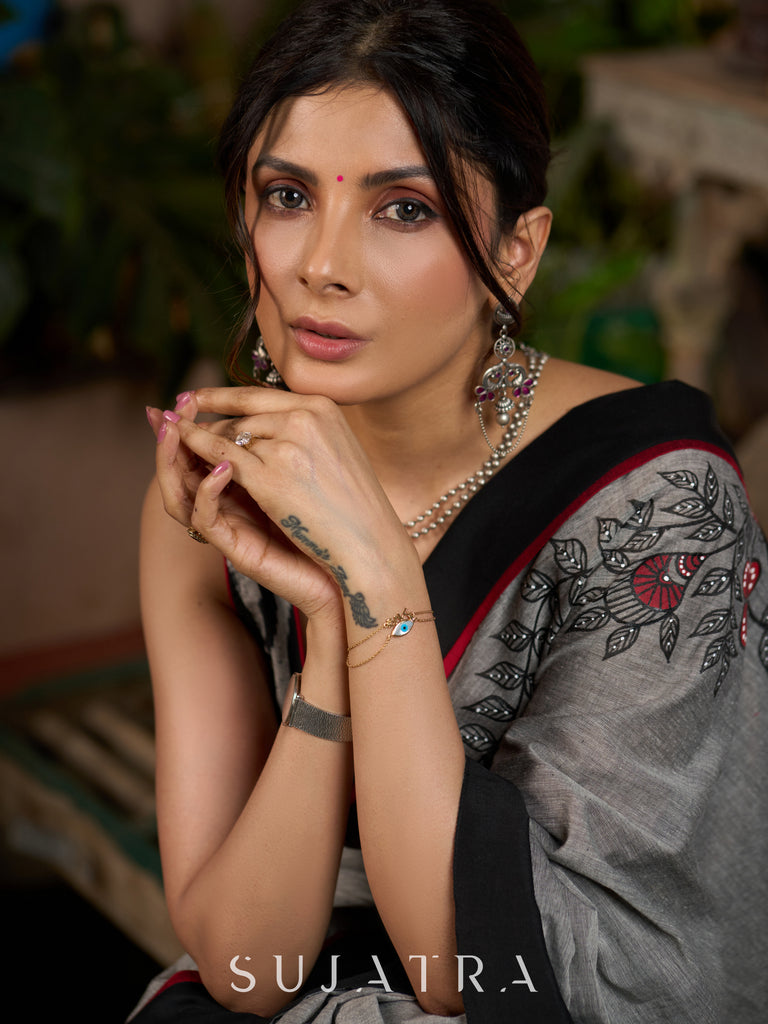 Sophisticated grey cotton saree with bold Madhubani artistry and timeless allure