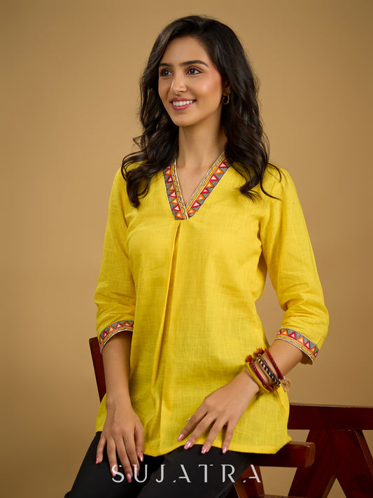 Traditional madhubani hand painting enhances this bright yellow cotton top.