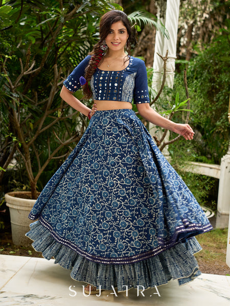 Modern folkloric layered indigo lehenga beautifully contrasted with a luminous full mirror work choli - Lehriya dupatta optional.