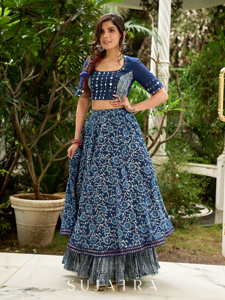Modern folkloric layered indigo lehenga beautifully contrasted with a luminous full mirror work choli - Lehriya dupatta optional.