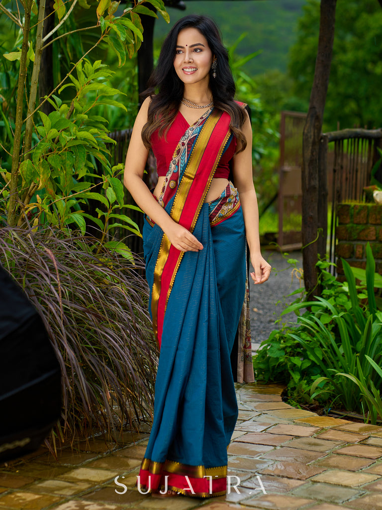 Elegant striped cotton saree in teal, enriched with hand-painted Kalamkari pallu