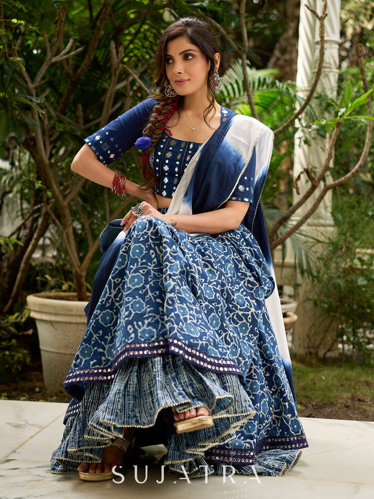 Modern folkloric layered indigo lehenga beautifully contrasted with a luminous full mirror work choli - Lehriya dupatta optional.