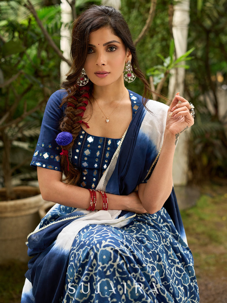 Modern folkloric layered indigo lehenga beautifully contrasted with a luminous full mirror work choli - Lehriya dupatta optional.