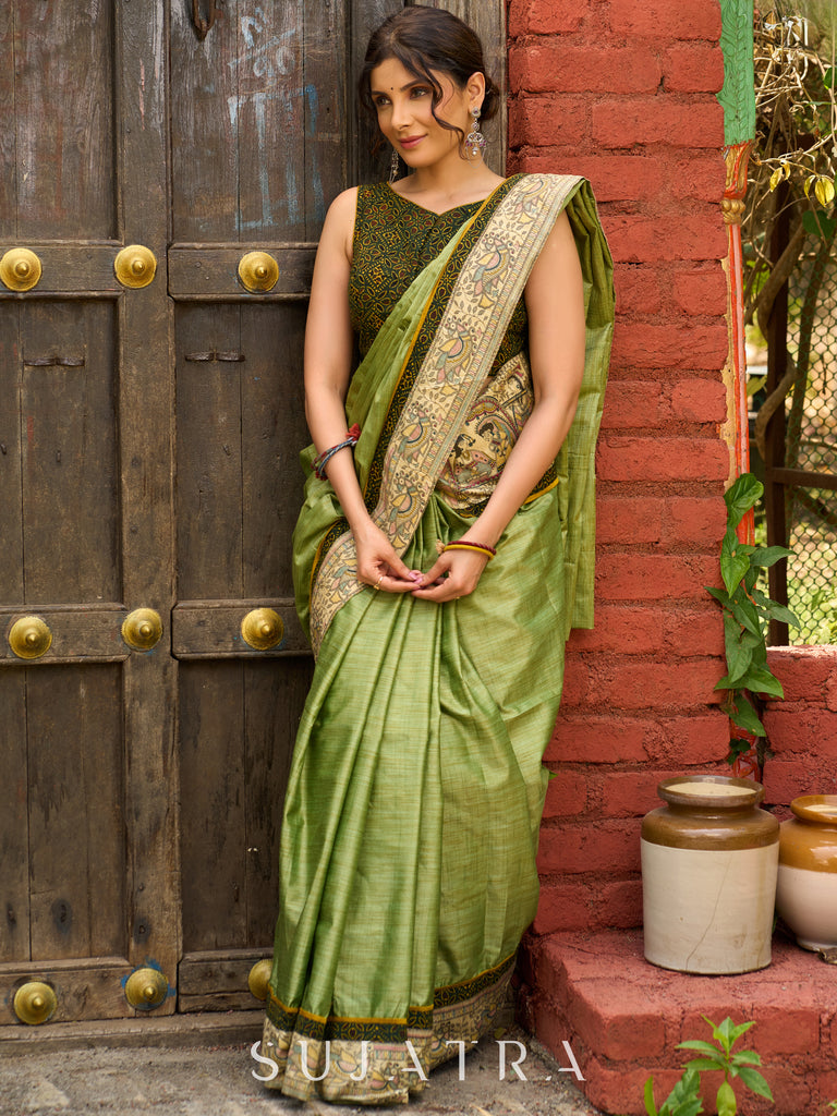 Pastel green semi-silk saree featuring Madhubani artwork on pallu and border