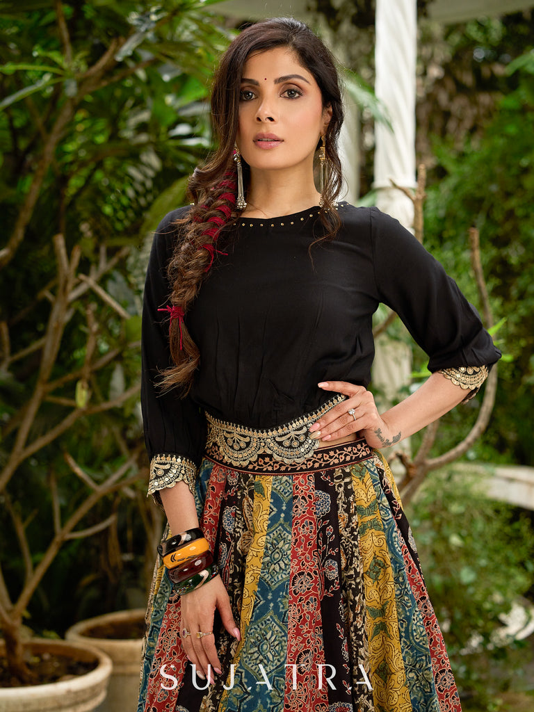 Modern colourful Ajrakh lehenga beautifully contrasted by a sleek black gathered topwear.