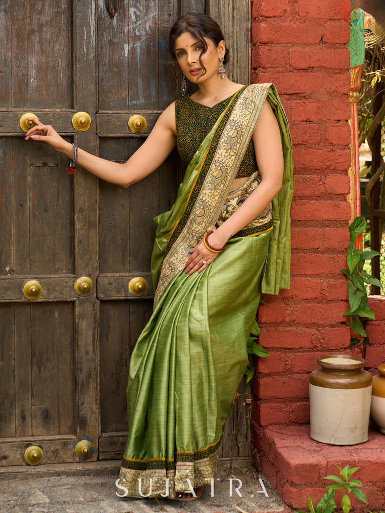 Pastel green semi-silk saree featuring Madhubani artwork on pallu and border