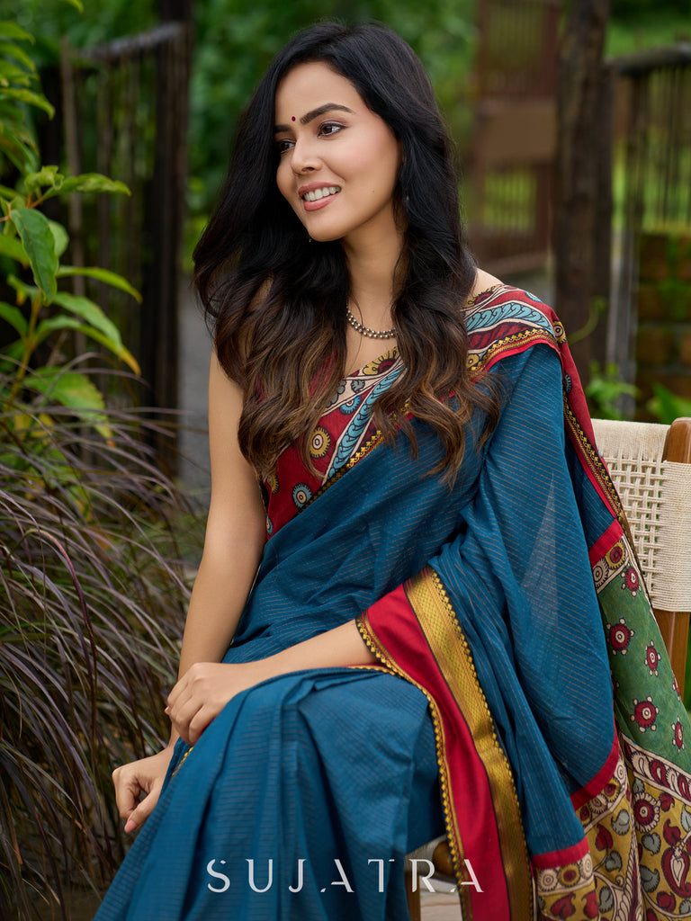 Elegant striped cotton saree in teal, enriched with hand-painted Kalamkari pallu