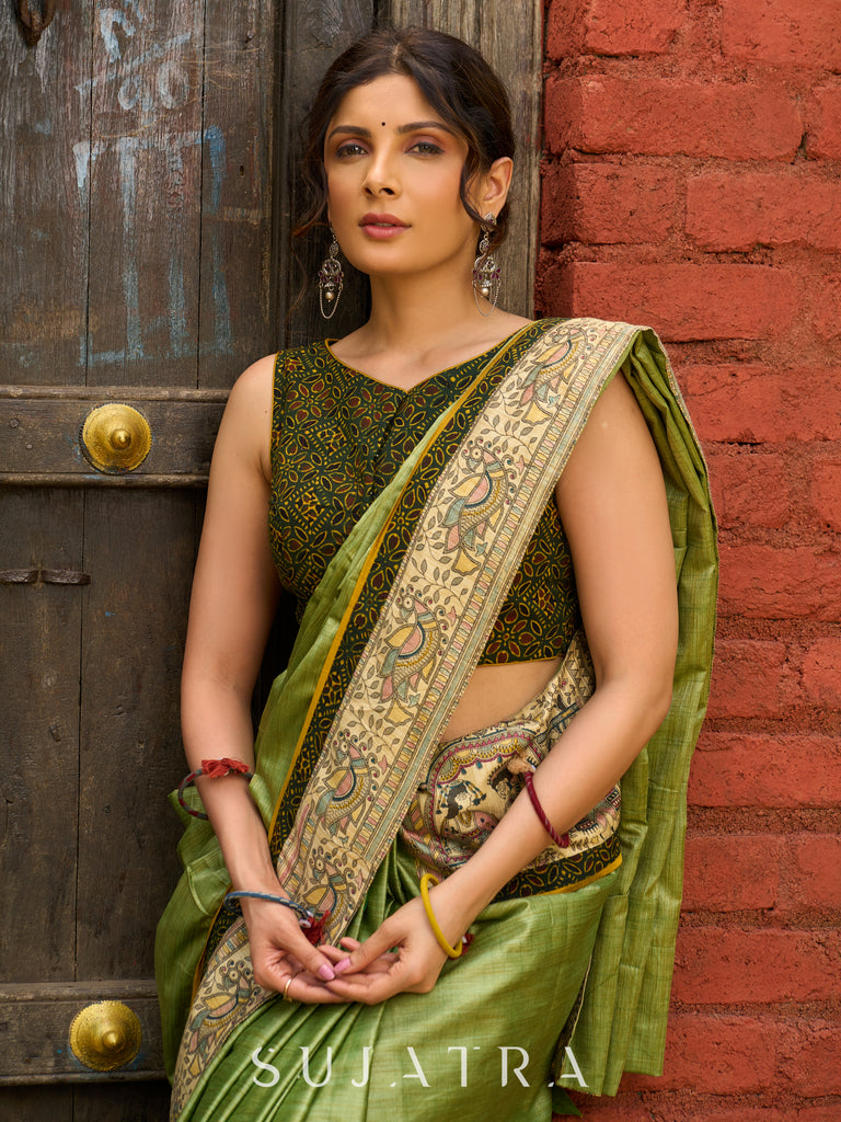 Pastel green semi-silk saree featuring Madhubani artwork on pallu and border