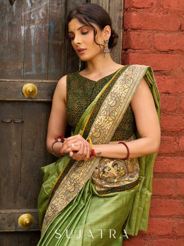 Pastel green semi-silk saree featuring Madhubani artwork on pallu and border