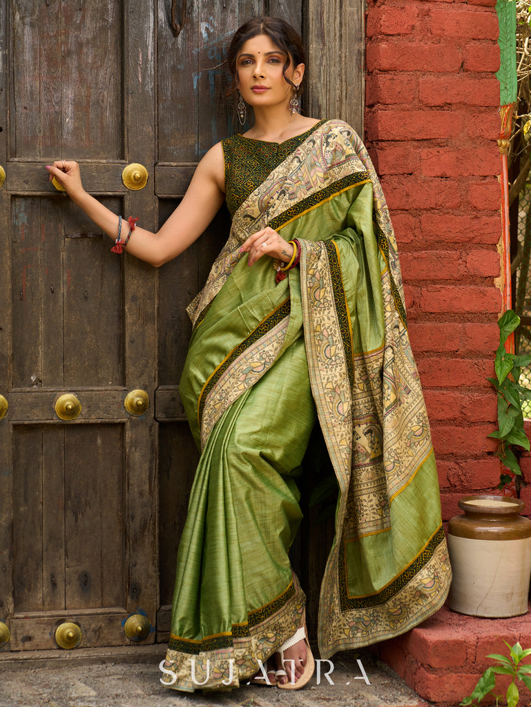 Pastel green semi-silk saree featuring Madhubani artwork on pallu and border