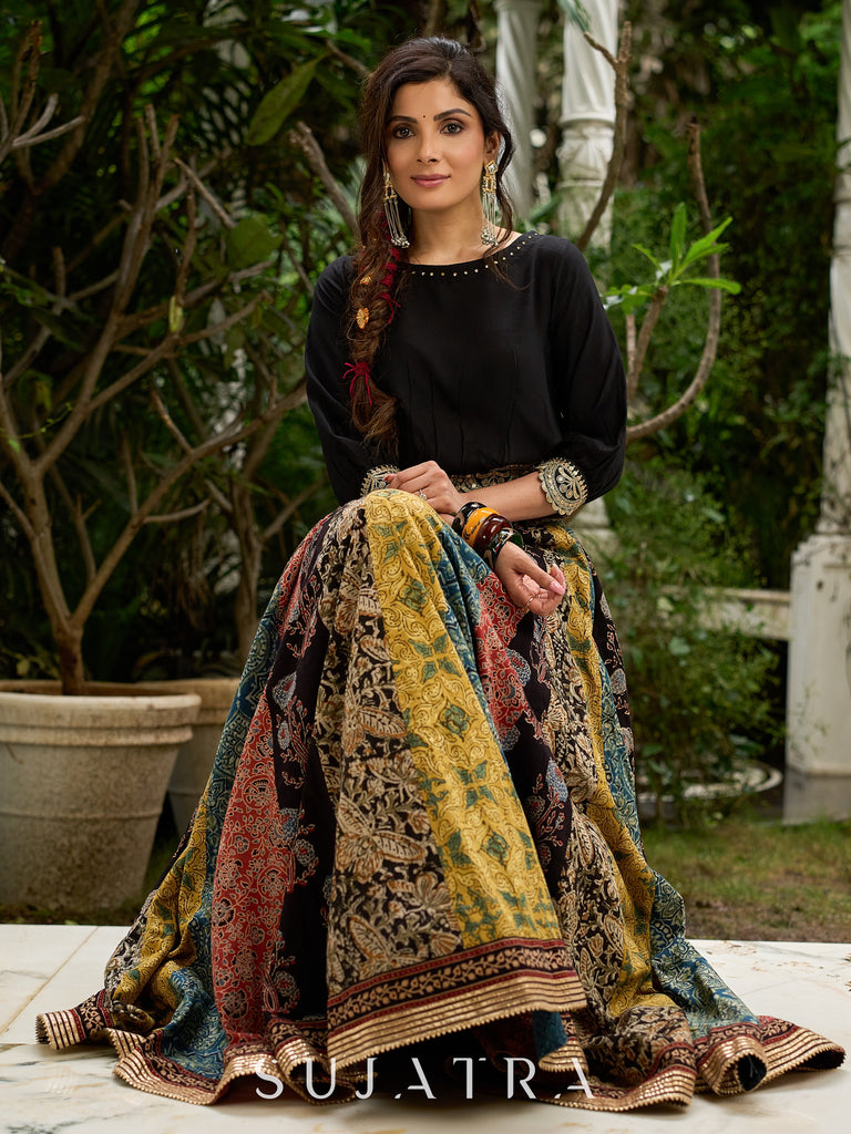 Modern colourful Ajrakh lehenga beautifully contrasted by a sleek black gathered topwear.