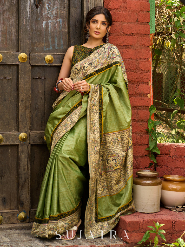 Pastel green semi-silk saree featuring Madhubani artwork on pallu and border