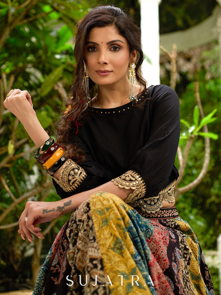 Modern colourful Ajrakh lehenga beautifully contrasted by a sleek black gathered topwear.