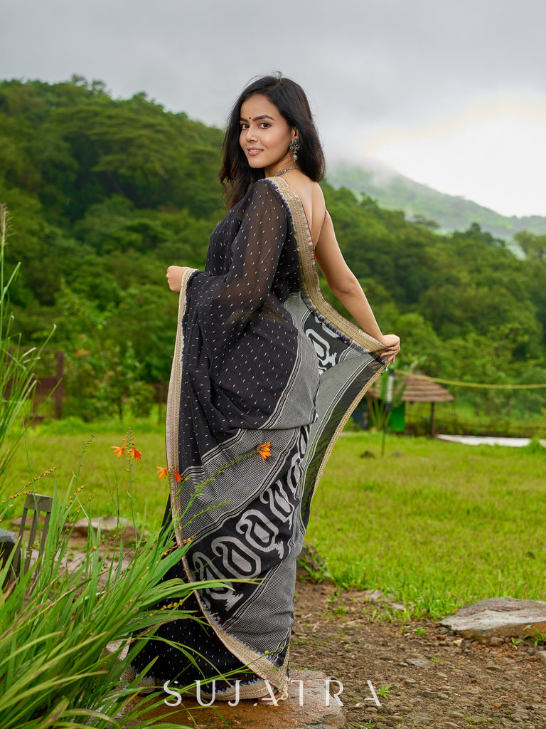 Classic black cotton saree featuring intricate weave and radiant zari edges
