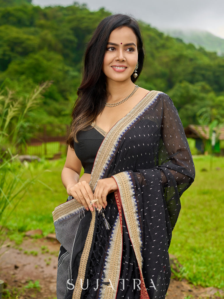 Classic black cotton saree featuring intricate weave and radiant zari edges