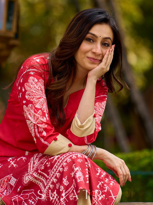 Culturally rooted red kurta displaying classic Warli designs with subtle beige touches
