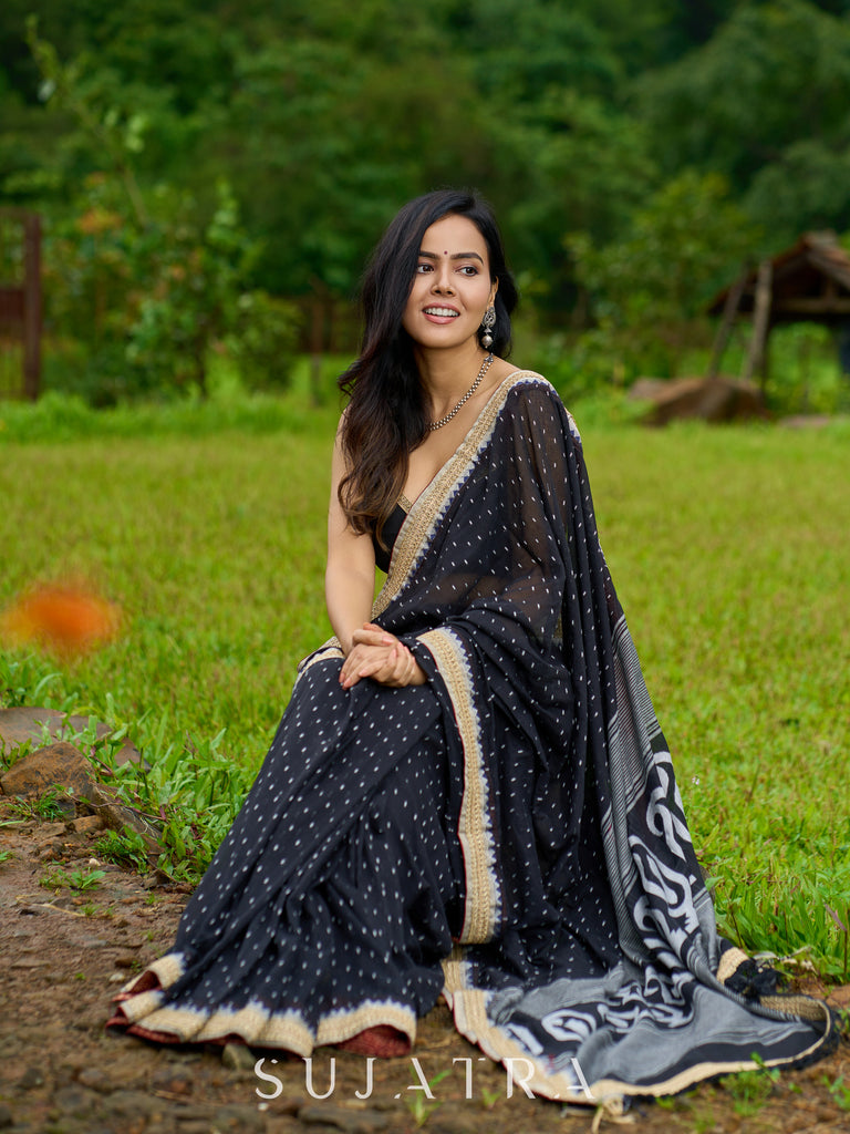 Classic black cotton saree featuring intricate weave and radiant zari edges