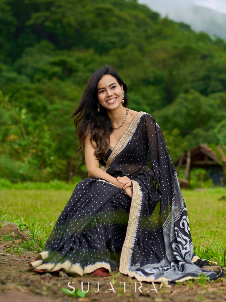 Classic black cotton saree featuring intricate weave and radiant zari edges