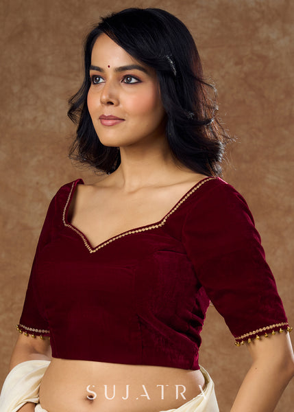 Rich maroon velvet blouse with subtle embroidery & gold detailing on sleeves