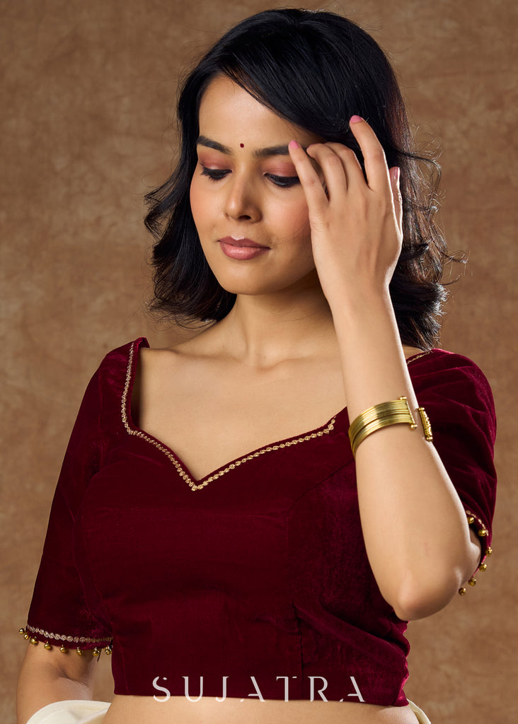 Rich maroon velvet blouse with subtle embroidery & gold detailing on sleeves