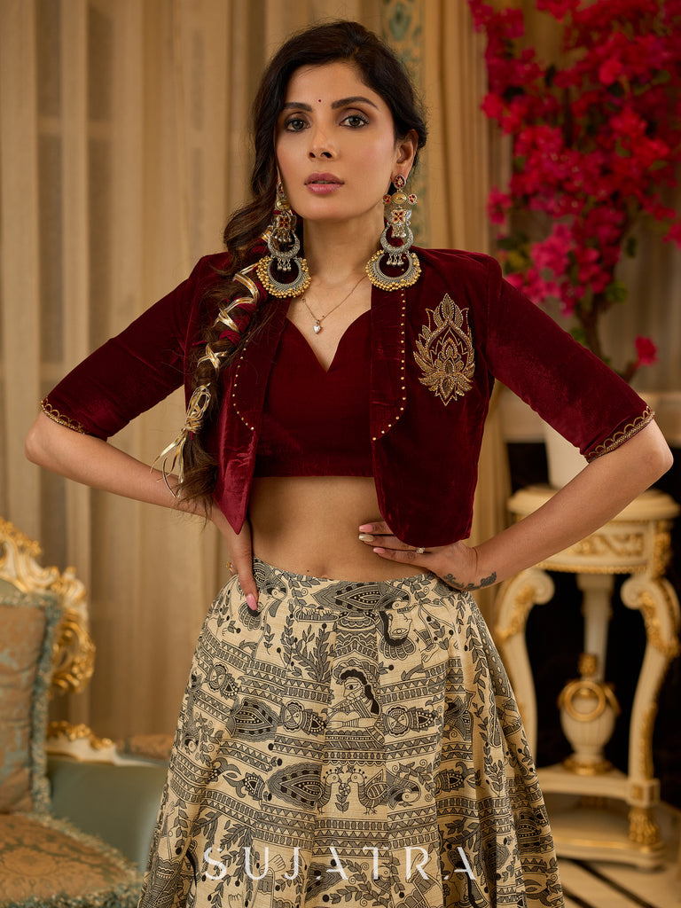 Madhubani print lehenga with a scalloped hem, paired with a rich maroon velvet blouse - Short Jacket with elegant brooch style embroidery Optional