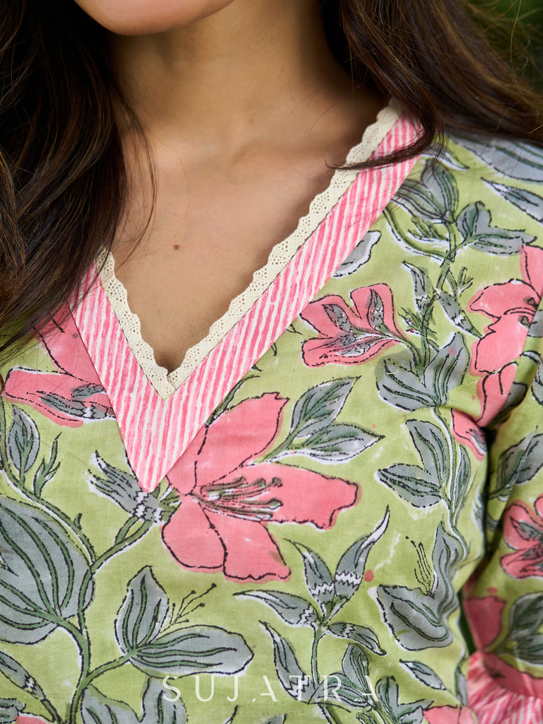 Graceful Pista Green Dress with Contrasting Pink Touches and Lace Detailing